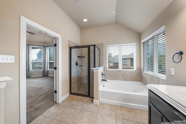 bathroom featuring vanity, tile patterned floors, lofted ceiling, and independent shower and bath