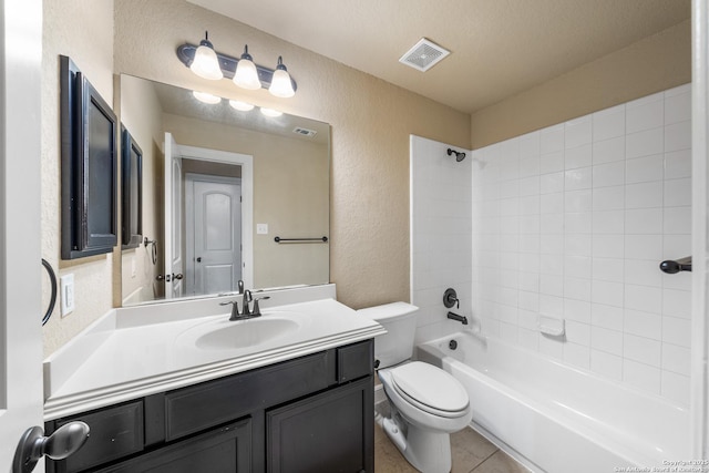 full bathroom with tiled shower / bath, vanity, tile patterned floors, and toilet