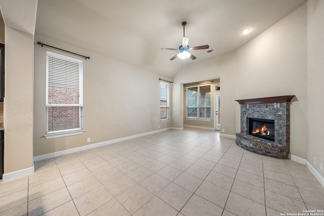 unfurnished living room featuring lofted ceiling, light tile patterned floors, a fireplace, and ceiling fan