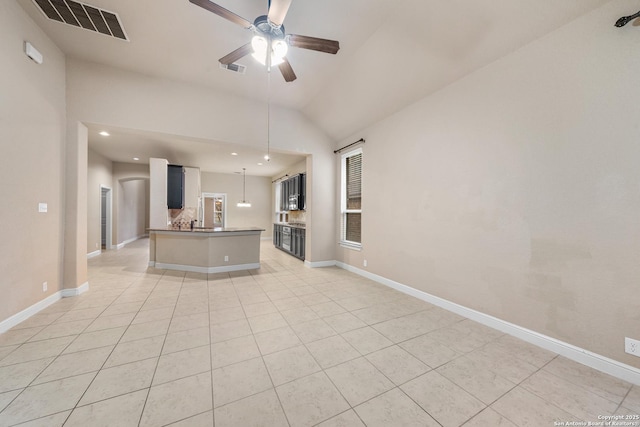 kitchen with white cabinets, light tile patterned floors, vaulted ceiling, and ceiling fan