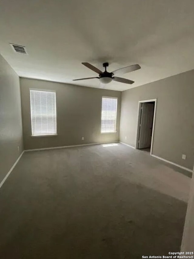 unfurnished room with ceiling fan and carpet flooring