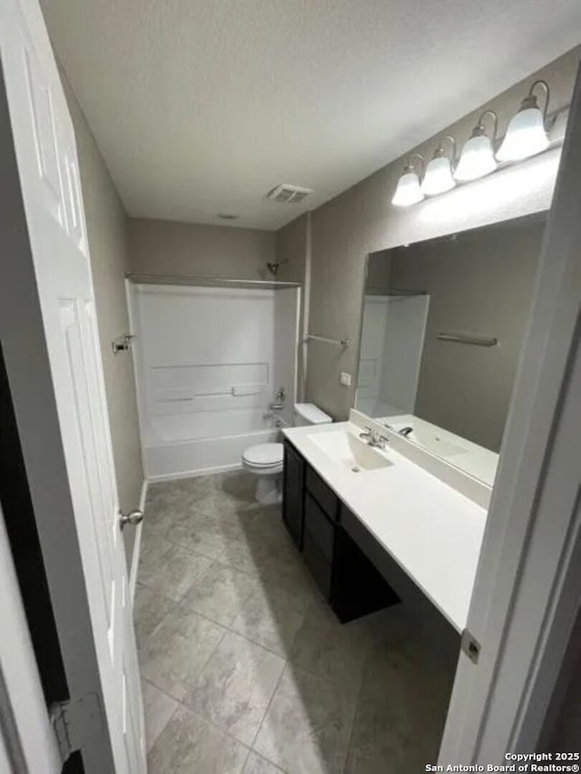 full bathroom with tile patterned flooring, toilet, shower / bathtub combination, a textured ceiling, and vanity