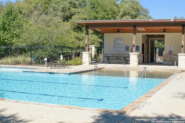 view of swimming pool with a patio and ceiling fan