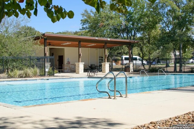 view of pool with a patio area and ceiling fan