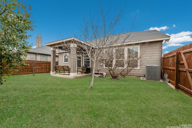 rear view of property featuring a patio area, a lawn, and central AC unit