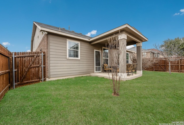 rear view of property with a patio and a yard