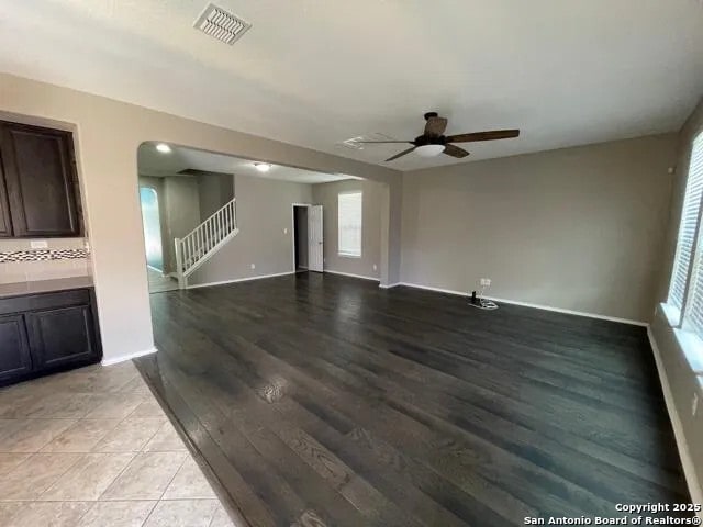 unfurnished living room featuring light hardwood / wood-style floors and ceiling fan