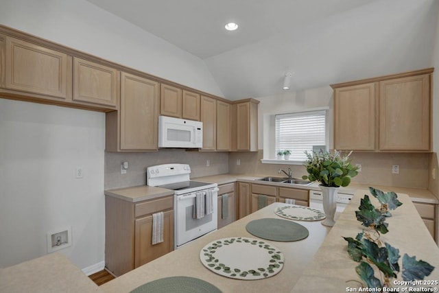 kitchen with white appliances, a sink, vaulted ceiling, light countertops, and tasteful backsplash