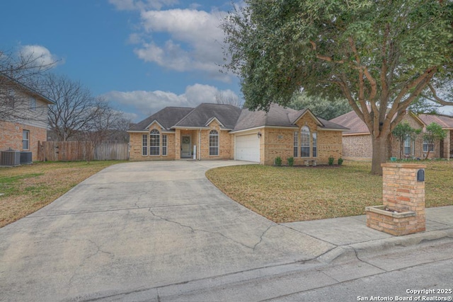 ranch-style home featuring concrete driveway, a front yard, fence, a garage, and cooling unit