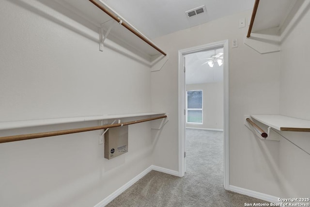 walk in closet featuring light colored carpet and visible vents