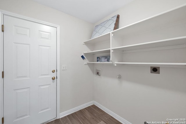 clothes washing area with laundry area, baseboards, wood finished floors, hookup for a washing machine, and electric dryer hookup