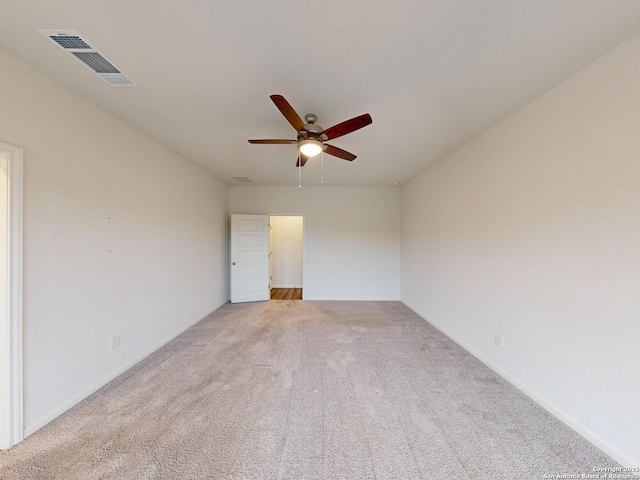 unfurnished room featuring light colored carpet and ceiling fan