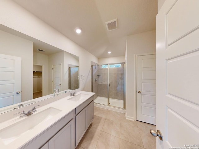 bathroom with tile patterned flooring, vanity, and a shower with shower door