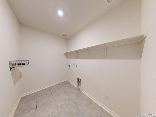 clothes washing area featuring gas dryer hookup, washer hookup, light tile patterned floors, and electric dryer hookup