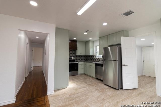 kitchen featuring decorative backsplash and appliances with stainless steel finishes