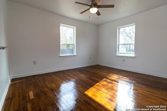 spare room featuring ceiling fan and dark hardwood / wood-style flooring