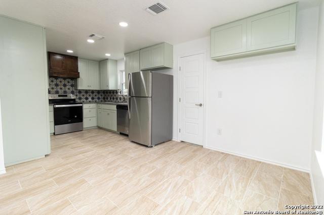 kitchen with tasteful backsplash and stainless steel appliances