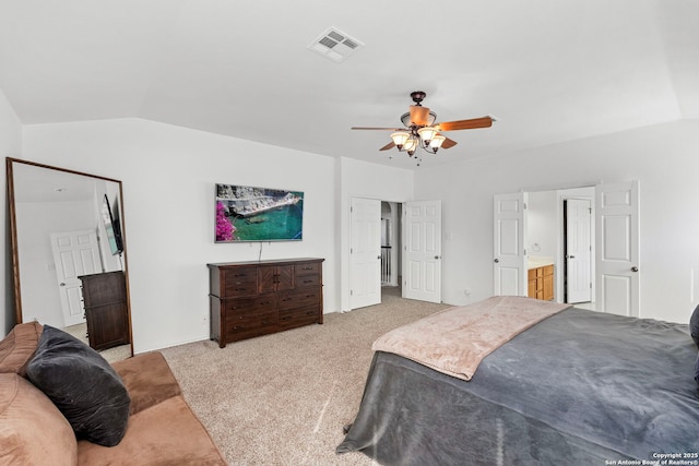 bedroom featuring ceiling fan, light colored carpet, lofted ceiling, and connected bathroom