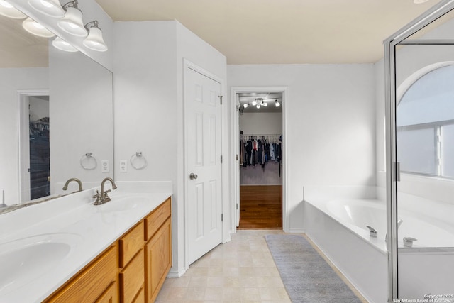 bathroom featuring vanity and a washtub