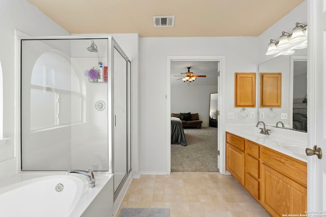 bathroom with vanity and independent shower and bath