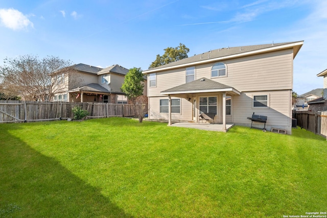 back of house featuring a yard and a patio area