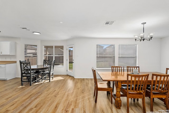 dining room featuring light hardwood / wood-style flooring and a chandelier