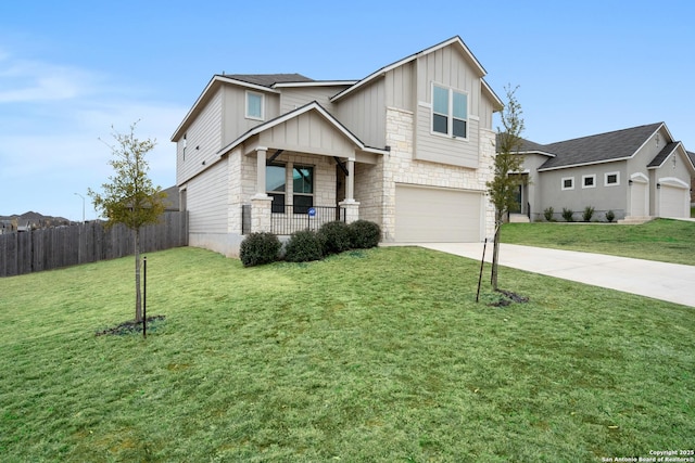 view of front of house featuring fence, driveway, stone siding, board and batten siding, and a front yard