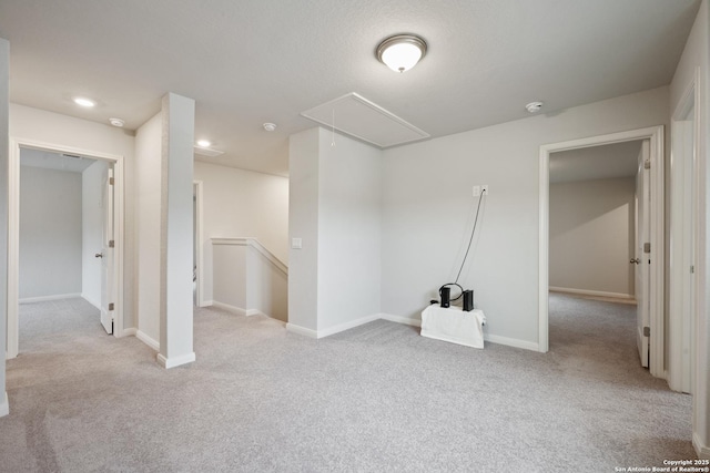 below grade area with baseboards and light colored carpet