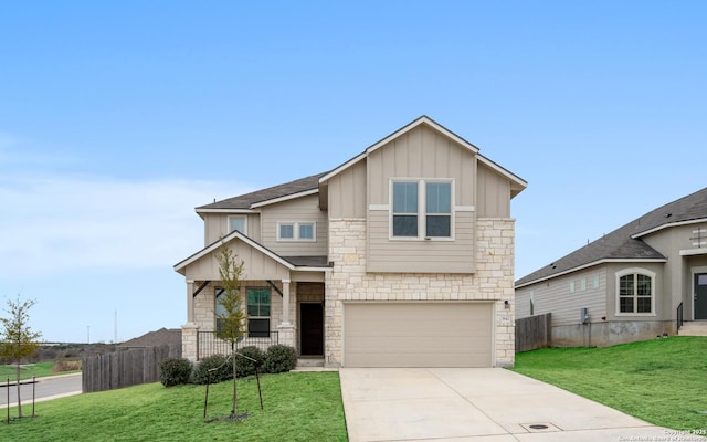 craftsman-style house featuring board and batten siding, driveway, a front lawn, and fence