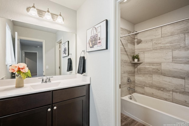 bathroom featuring shower / washtub combination, vanity, and wood finished floors