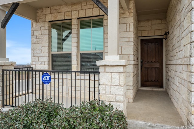 property entrance featuring stone siding