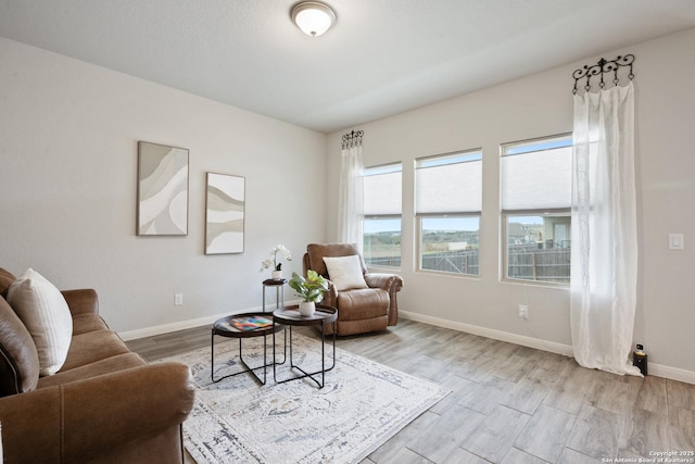 living room featuring wood finished floors and baseboards