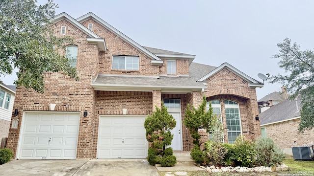 front of property with a garage and central AC unit