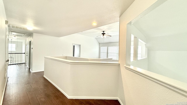 hallway featuring lofted ceiling and dark hardwood / wood-style flooring