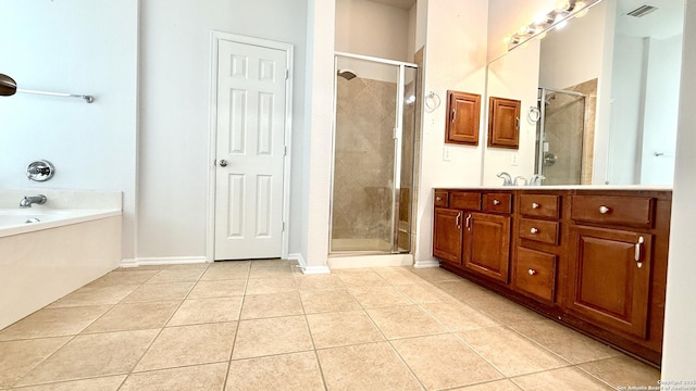 bathroom with tile patterned flooring, vanity, and separate shower and tub