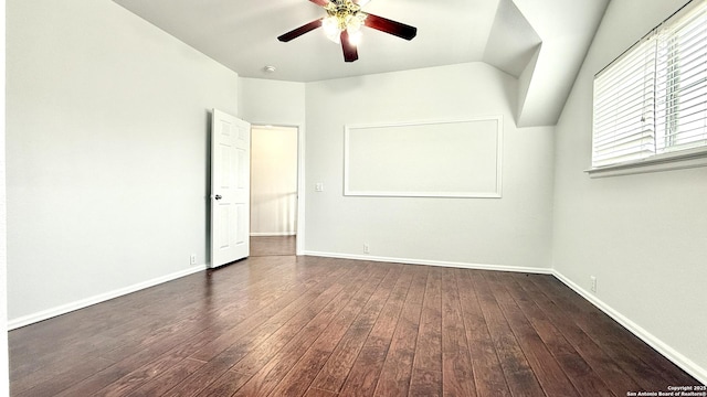 empty room with lofted ceiling, dark hardwood / wood-style floors, and ceiling fan