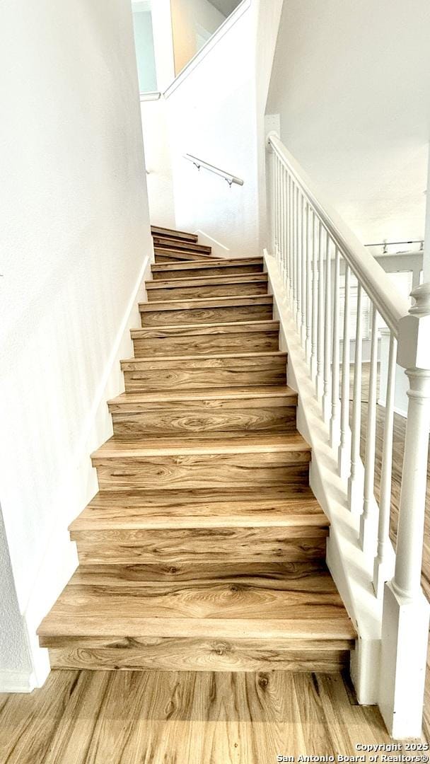 stairway featuring hardwood / wood-style flooring