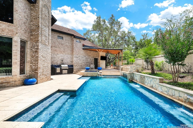 view of swimming pool with a patio, pool water feature, and area for grilling