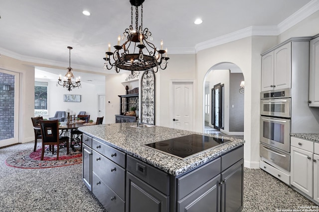 kitchen with a kitchen island with sink, double oven, gray cabinetry, white cabinets, and black electric cooktop