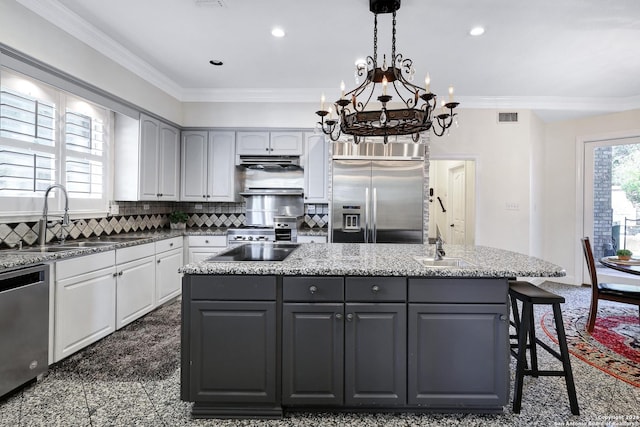 kitchen featuring sink, gray cabinetry, appliances with stainless steel finishes, a kitchen island with sink, and white cabinets