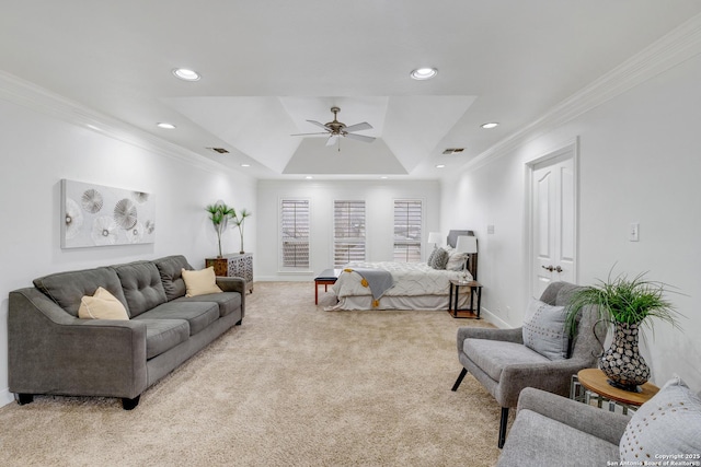 bedroom featuring light carpet, ornamental molding, a raised ceiling, and ceiling fan