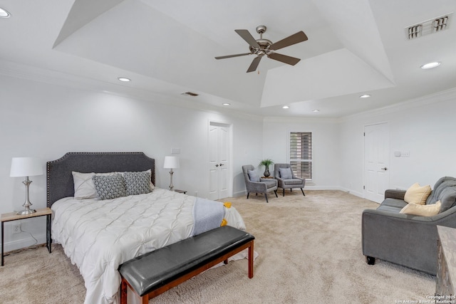 carpeted bedroom featuring crown molding, ceiling fan, and a raised ceiling