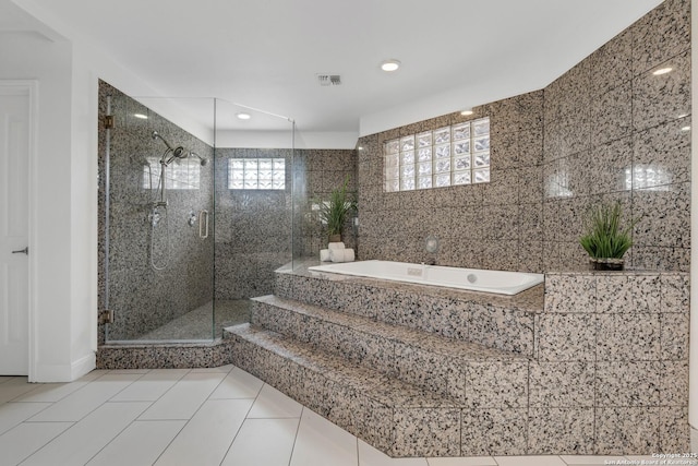 bathroom with shower with separate bathtub and tile patterned flooring