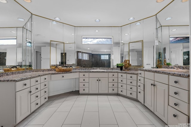 bathroom with vanity, a shower, and tile patterned floors