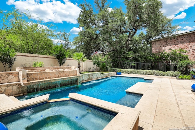 view of swimming pool with an in ground hot tub and pool water feature