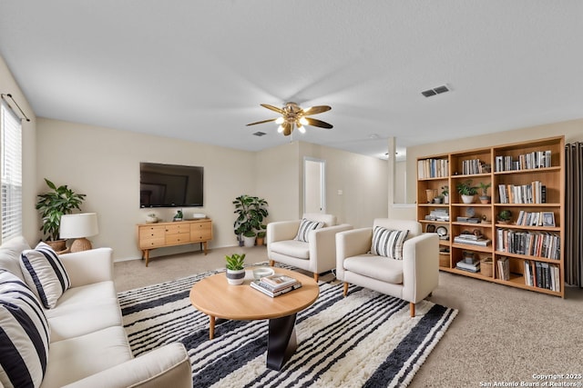 carpeted living room featuring ceiling fan