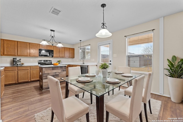 dining space with light wood-type flooring