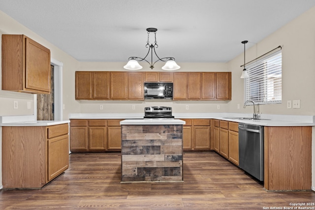 kitchen featuring pendant lighting, sink, stainless steel appliances, and dark hardwood / wood-style floors