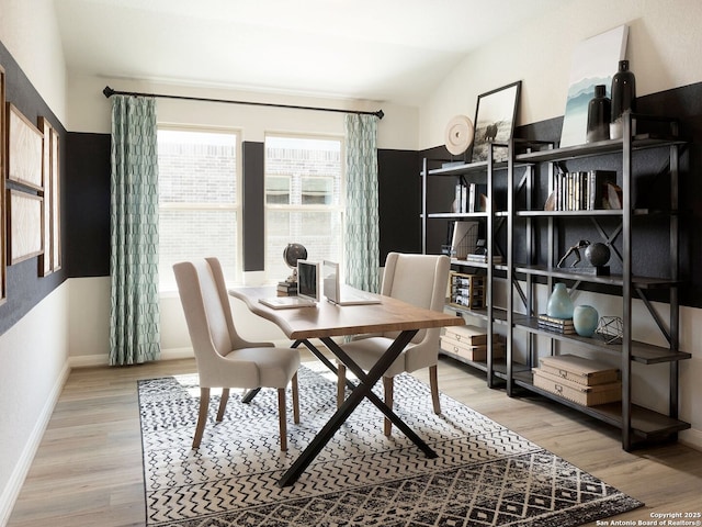 dining area with wood-type flooring and lofted ceiling