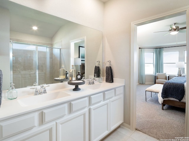 bathroom featuring a shower with door, ceiling fan, tile patterned flooring, vanity, and vaulted ceiling